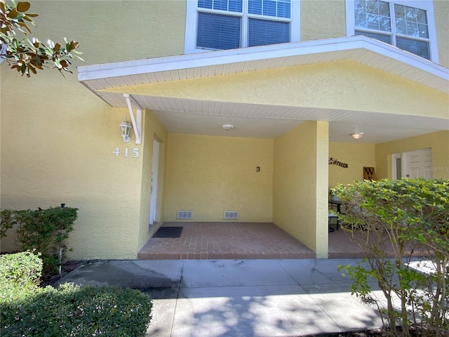 entrance to property with a patio area