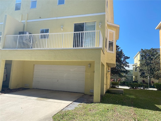 back of house featuring a balcony and a garage