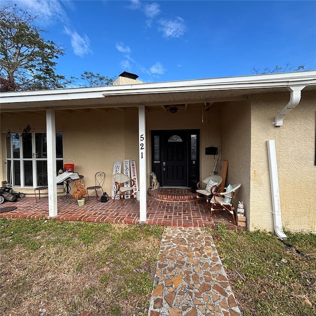 property entrance featuring a patio