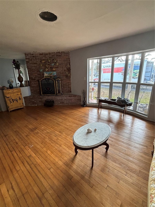 living room featuring a fireplace and light wood-type flooring