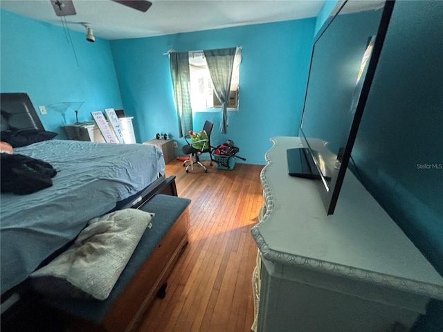 bedroom with hardwood / wood-style flooring and ceiling fan