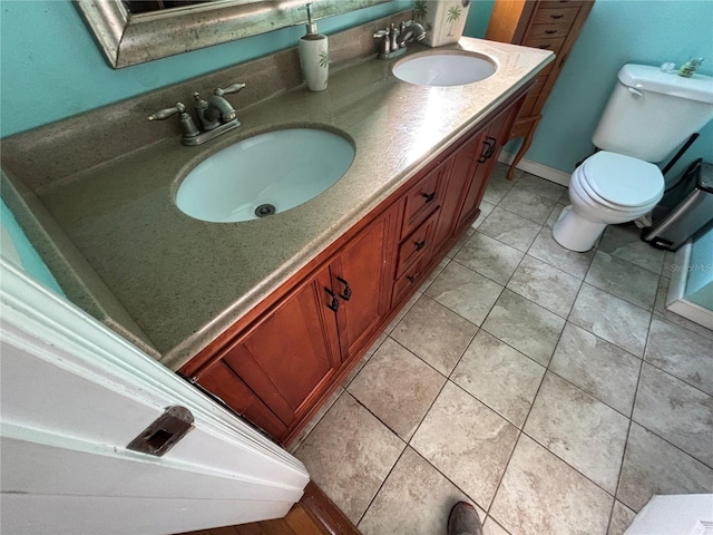 bathroom with vanity, tile patterned flooring, and toilet