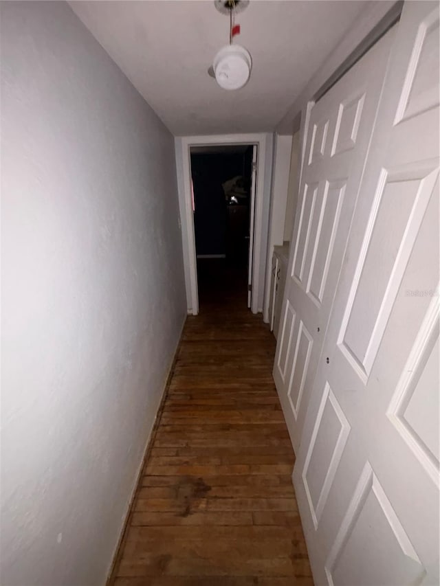 hallway with dark hardwood / wood-style flooring