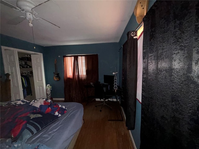 bedroom featuring wood-type flooring, ceiling fan, and a closet