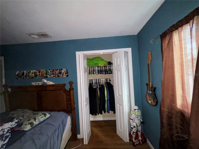 bedroom featuring dark hardwood / wood-style floors and a closet