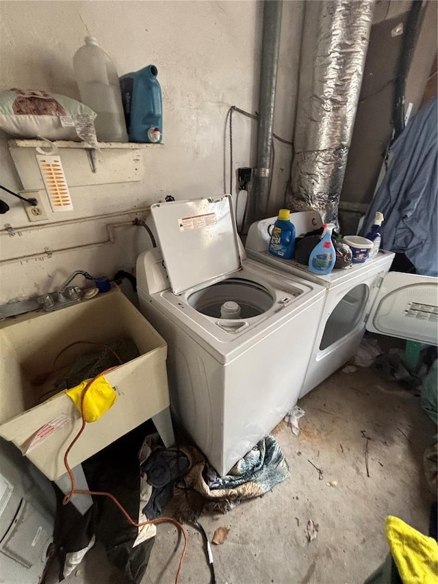 clothes washing area with washing machine and dryer