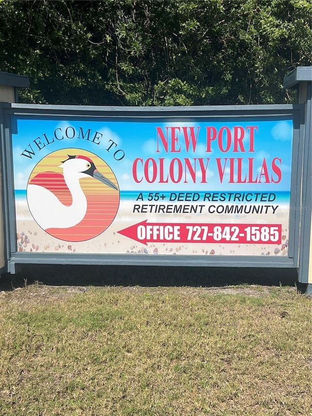 community sign featuring a lawn