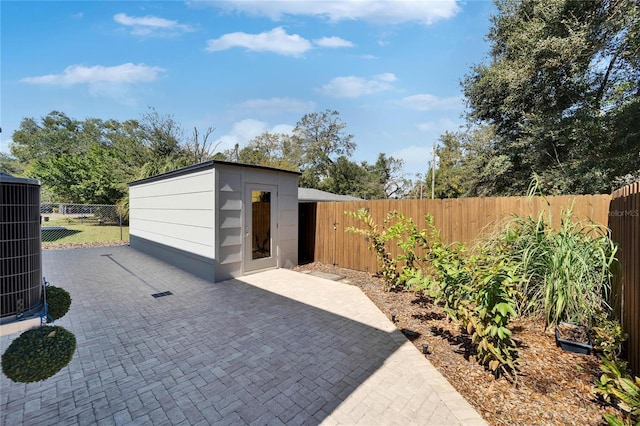 view of patio / terrace with a storage shed and central AC unit