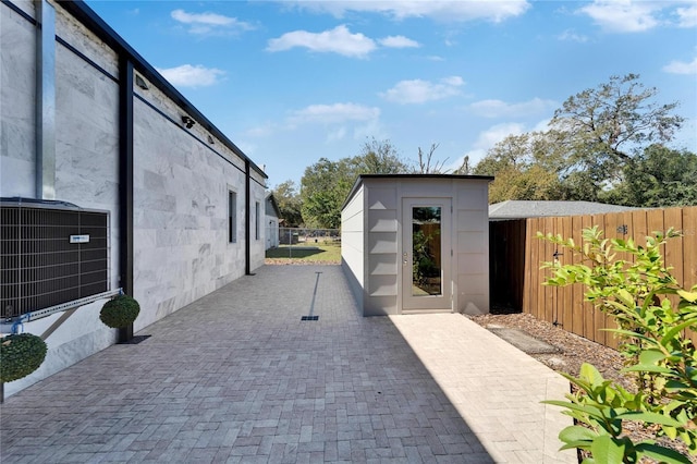 view of patio / terrace featuring central AC and a shed