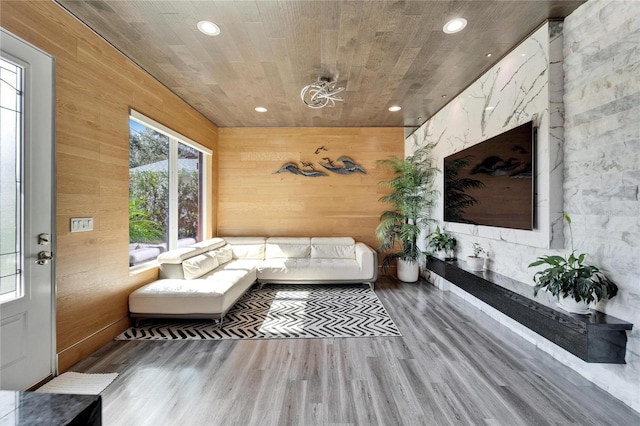 living room with wood ceiling, wooden walls, and hardwood / wood-style flooring