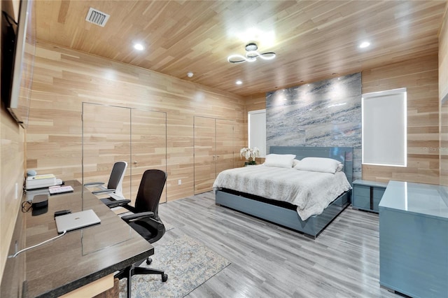 bedroom featuring hardwood / wood-style flooring, wooden walls, and wooden ceiling