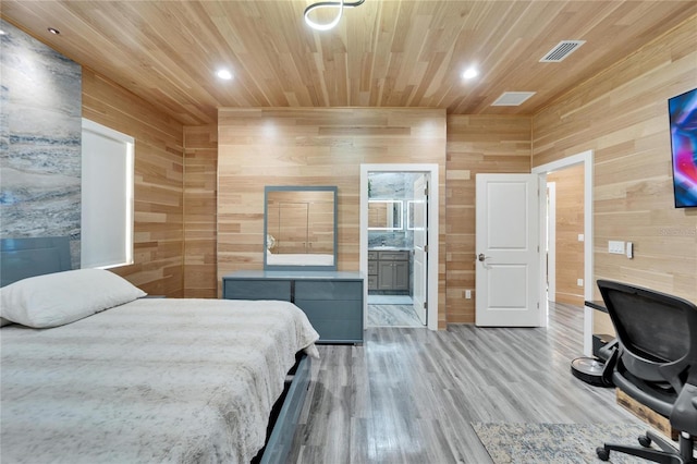 bedroom featuring wood ceiling, ensuite bath, wood walls, and light wood-type flooring