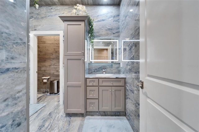 bathroom with tile walls and vanity