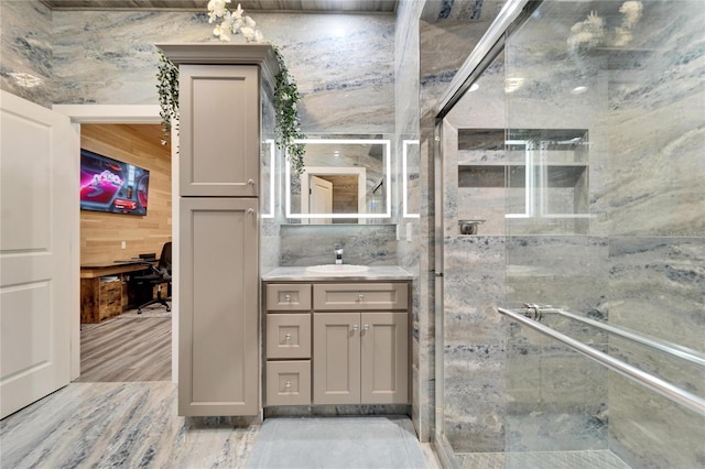 bathroom with vanity and a shower with shower door