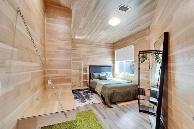 bedroom with hardwood / wood-style flooring and wooden ceiling