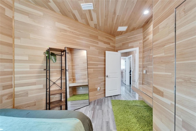 unfurnished bedroom with wood-type flooring, wooden walls, and wooden ceiling