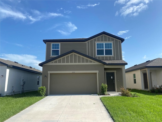 view of front of property with a garage and a front lawn