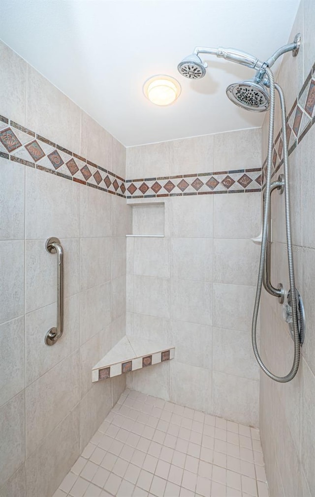 bathroom with tiled shower