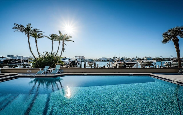 view of pool featuring a water view