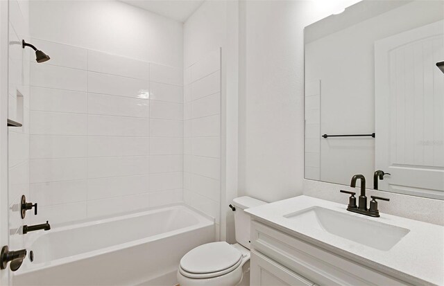 bathroom with toilet,  shower combination, and vanity