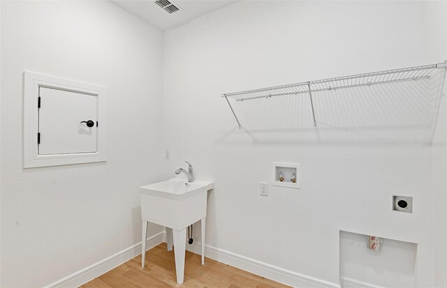 washroom with laundry area, electric dryer hookup, visible vents, hookup for a washing machine, and light wood-style floors