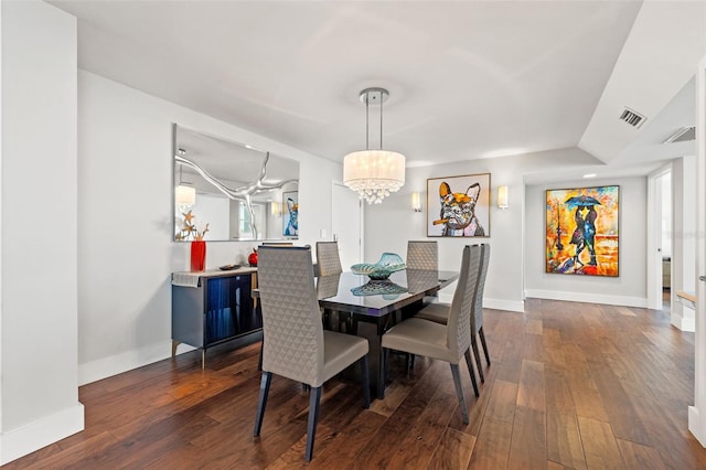 dining area featuring a notable chandelier and dark hardwood / wood-style flooring