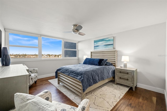 bedroom with ceiling fan and dark hardwood / wood-style flooring