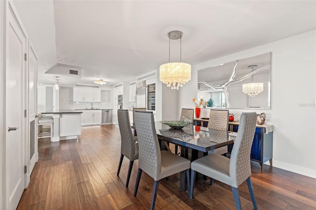 dining room featuring a notable chandelier and dark hardwood / wood-style flooring