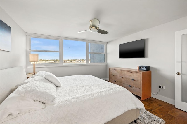 bedroom featuring dark hardwood / wood-style flooring and ceiling fan