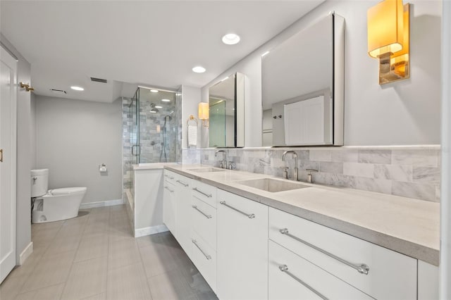 bathroom with walk in shower, tile patterned floors, toilet, vanity, and decorative backsplash