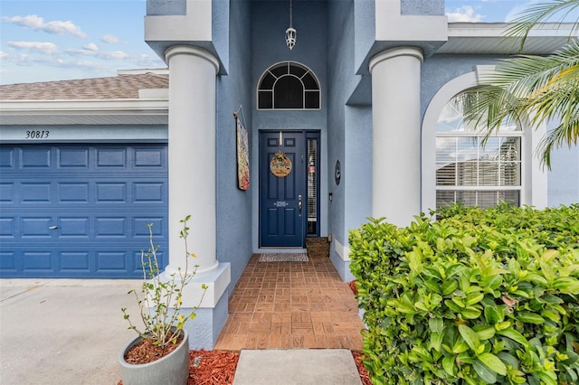 view of exterior entry with a garage