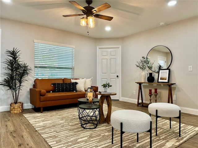 sitting room featuring hardwood / wood-style floors and ceiling fan
