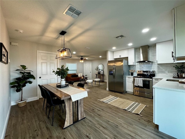 dining room with dark wood-type flooring, ceiling fan, and sink