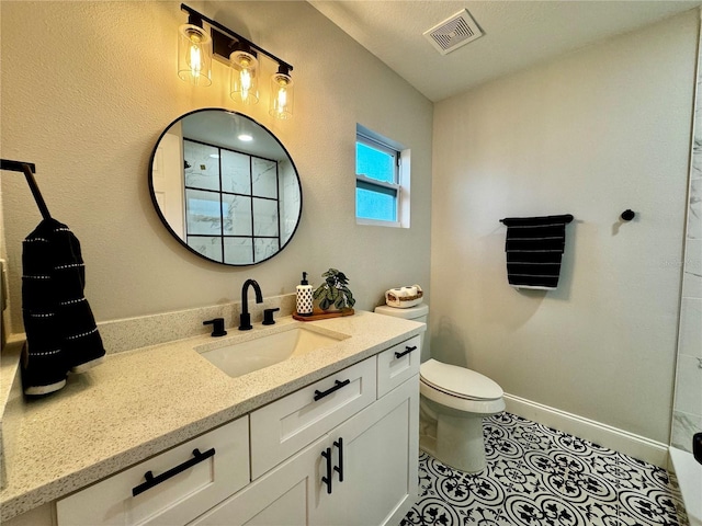 bathroom with vanity, tile patterned floors, and toilet