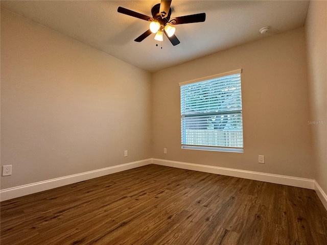 empty room featuring dark hardwood / wood-style floors and ceiling fan