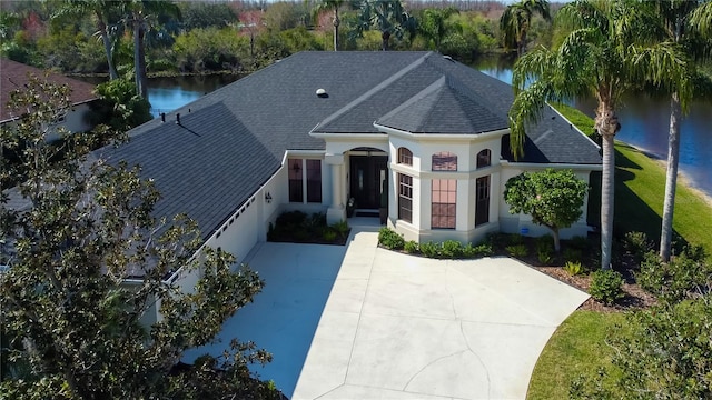 view of front of house with a water view