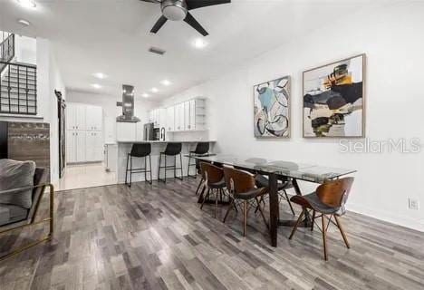 dining space featuring hardwood / wood-style floors and ceiling fan