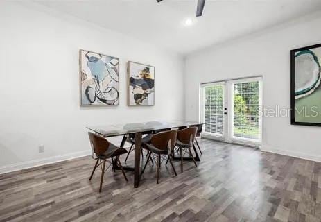 dining space with dark wood-type flooring and ceiling fan