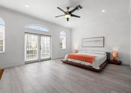 bedroom featuring hardwood / wood-style floors, access to outside, french doors, and ceiling fan