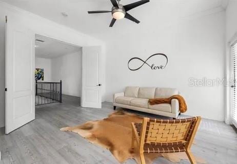 living room featuring hardwood / wood-style flooring and ceiling fan