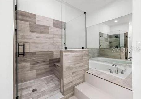 bathroom featuring separate shower and tub