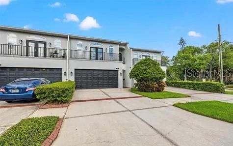 view of front of house featuring a balcony and a garage