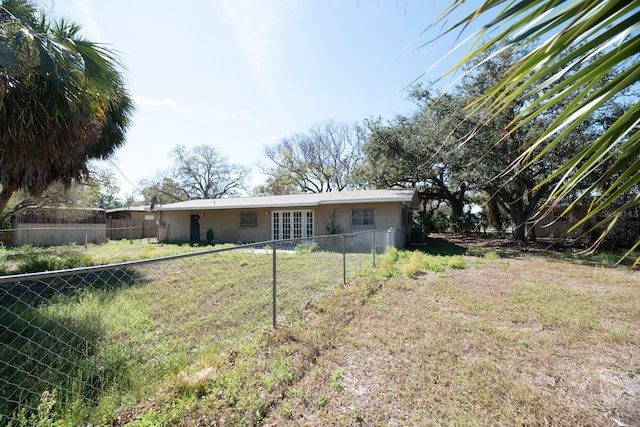 rear view of house with fence