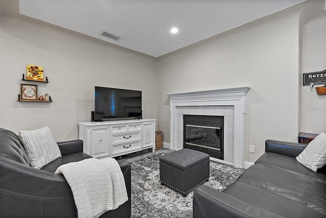 living room with a tile fireplace