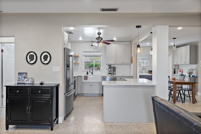 kitchen featuring sink, high quality fridge, and white cabinets