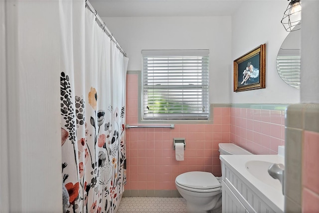 bathroom with tile walls, tile patterned flooring, vanity, toilet, and a shower with shower curtain