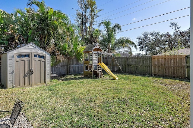 view of yard with a playground and a storage unit