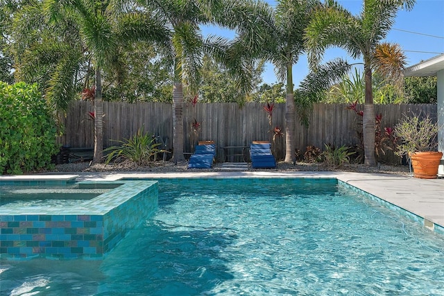 view of pool with an in ground hot tub