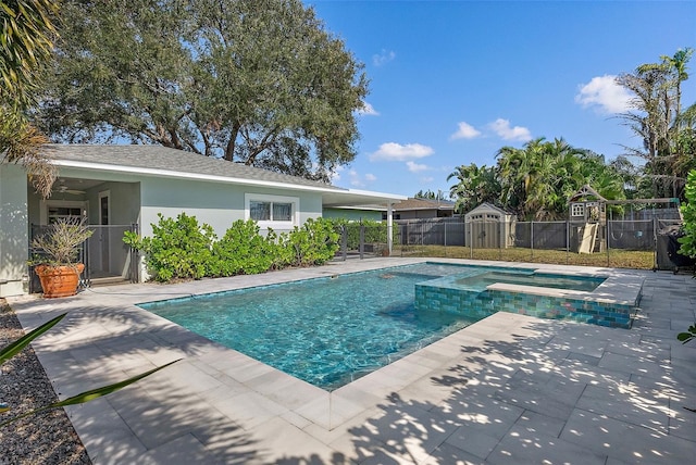 view of pool featuring a patio area and an in ground hot tub