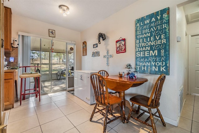 dining room featuring light tile patterned flooring